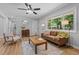 Cozy living room with wood floors, a comfortable sofa, and lots of natural light at 908 W Garden St, Sanford, NC 27330