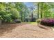 A charming home with a well-manicured backyard featuring mature trees, shrubs, and a covered porch at 9417 Greenfield Dr, Raleigh, NC 27615