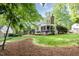 Charming home featuring a spacious backyard with a screened-in porch and a cozy outdoor space at 9417 Greenfield Dr, Raleigh, NC 27615