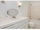 Bathroom with white cabinets, oval mirror, vanity lighting, and a shower-tub combination at 9417 Greenfield Dr, Raleigh, NC 27615