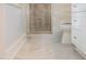 Bathroom featuring gray tile flooring, a toilet, and glass enclosed shower at 9417 Greenfield Dr, Raleigh, NC 27615