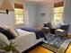 Bedroom featuring two lounge chairs, windows, and a blue accent rug at 9417 Greenfield Dr, Raleigh, NC 27615