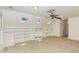 Bright bonus room with skylights, built-in shelving, carpet floors, and ceiling fan at 9417 Greenfield Dr, Raleigh, NC 27615