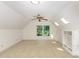 Bonus room featuring skylights, built-in shelving, carpeted floors, and great natural light at 9417 Greenfield Dr, Raleigh, NC 27615