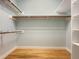 Walk in closet with hardwood floors and custom shelving at 9417 Greenfield Dr, Raleigh, NC 27615