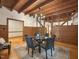 Dining room with wooden ceiling, wood paneling, hardwood floors and view to the kitchen at 9417 Greenfield Dr, Raleigh, NC 27615