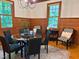 Dining room with wood paneling, a round glass table, and a rug providing an elegant setting at 9417 Greenfield Dr, Raleigh, NC 27615