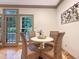 Cozy dining room with a round table and seating for four, complemented by natural light from the window at 9417 Greenfield Dr, Raleigh, NC 27615