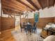 Stylish dining room with wooden ceiling, wood paneling, hardwood floors and view to the kitchen at 9417 Greenfield Dr, Raleigh, NC 27615