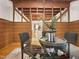 Close-up of dining room table and decor with wooden ceiling, wood paneling, and hardwood floors at 9417 Greenfield Dr, Raleigh, NC 27615