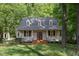 Charming two-story home with a welcoming front porch and well-manicured lawn at 9417 Greenfield Dr, Raleigh, NC 27615