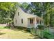 Charming home with a welcoming front porch, beautiful landscaping, and lush greenery, perfect for relaxation at 9417 Greenfield Dr, Raleigh, NC 27615