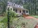 Charming home with inviting front porch, lush landscaping, and a classic lantern at 9417 Greenfield Dr, Raleigh, NC 27615