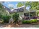 Exterior view of home with screened-in porch and lush landscaping at 9417 Greenfield Dr, Raleigh, NC 27615