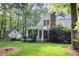 Charming home exterior with a screened porch, lush greenery, and a well-manicured lawn at 9417 Greenfield Dr, Raleigh, NC 27615