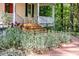 Charming home with front porch featuring rocking chairs, enhanced by colorful flowerbeds at 9417 Greenfield Dr, Raleigh, NC 27615