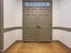 Inviting home entrance featuring double doors with transom window and neutral trim, complemented by warm hardwood floors at 9417 Greenfield Dr, Raleigh, NC 27615