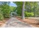 Charming home with a well-maintained front yard, a long driveway, and mature trees creating a serene setting at 9417 Greenfield Dr, Raleigh, NC 27615