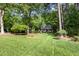 Charming home with a well-manicured front yard, mature trees, and lush greenery creating a peaceful setting at 9417 Greenfield Dr, Raleigh, NC 27615