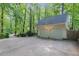 Spacious detached two-car garage with an expansive driveway surrounded by trees at 9417 Greenfield Dr, Raleigh, NC 27615