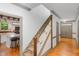 Hallway showcasing staircase and hardwood floors leading to the kitchen at 9417 Greenfield Dr, Raleigh, NC 27615