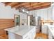 Bright kitchen with white cabinetry, a large island, stainless steel refrigerator, and wooden floors at 9417 Greenfield Dr, Raleigh, NC 27615