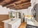 Bright kitchen featuring a large island, stainless steel appliances, wood ceiling beams and hardwood floors at 9417 Greenfield Dr, Raleigh, NC 27615