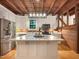 Bright kitchen with an island, modern appliances, and hardwood floors, offering a functional cooking space at 9417 Greenfield Dr, Raleigh, NC 27615
