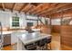 Kitchen showcasing a large island, stainless steel appliances, and warm wood accents against white cabinetry at 9417 Greenfield Dr, Raleigh, NC 27615