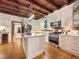 Bright kitchen with modern stainless steel appliances, white cabinetry, and a spacious island at 9417 Greenfield Dr, Raleigh, NC 27615