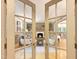 French doors lead to the living room with fireplace and seating at 9417 Greenfield Dr, Raleigh, NC 27615