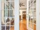 View of the living room through glass french doors and wood floors at 9417 Greenfield Dr, Raleigh, NC 27615
