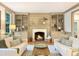 Cozy living room featuring built-in shelving, a fireplace, and sofas at 9417 Greenfield Dr, Raleigh, NC 27615