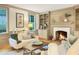 Inviting living room showcasing a fireplace, built-in shelving, with a comfortable sofa and windows at 9417 Greenfield Dr, Raleigh, NC 27615