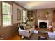 Living room with a fireplace, hardwood floors, and abundant natural light at 9417 Greenfield Dr, Raleigh, NC 27615