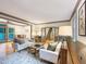 Spacious living room with hardwood floors leading to an adjacent dining area, doors to backyard, and stairway at 9417 Greenfield Dr, Raleigh, NC 27615