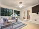 Inviting screened-in porch with a ceiling fan, comfortable sofa, and an outdoor view at 9417 Greenfield Dr, Raleigh, NC 27615