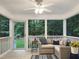 Relaxing screened-in porch offers comfortable seating and backyard views at 9417 Greenfield Dr, Raleigh, NC 27615
