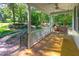 Spacious porch with a swing and ceiling fan, perfect for enjoying the outdoors at 9417 Greenfield Dr, Raleigh, NC 27615