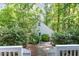 Backyard view of charming shed surrounded by lush trees and greenery at 9417 Greenfield Dr, Raleigh, NC 27615