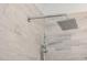Close up of shower featuring gray tile and modern shower head at 9417 Greenfield Dr, Raleigh, NC 27615