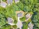 Aerial view of the property nestled among mature trees, showcasing its location in a suburban neighborhood at 1001 Dairy House Ct, Wake Forest, NC 27587