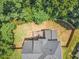 An aerial view showcasing the landscaped backyard, bordered by lush trees and privacy fence at 1001 Dairy House Ct, Wake Forest, NC 27587