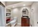 Small bathroom with a sleek modern vanity and tiled floors and built-in shelves at 1001 Dairy House Ct, Wake Forest, NC 27587