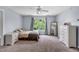 Cozy bedroom with light blue walls, plush carpeting, and a bright window view at 1001 Dairy House Ct, Wake Forest, NC 27587