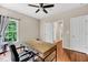 Functional home office with a wooden desk, office chair, natural light, and hardwood floors at 1001 Dairy House Ct, Wake Forest, NC 27587