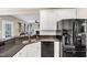 Functional kitchen featuring granite countertops, white cabinets, and black appliances at 1001 Dairy House Ct, Wake Forest, NC 27587