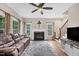 Spacious living room features a fireplace, ceiling fan, comfortable seating, and hardwood floors at 1001 Dairy House Ct, Wake Forest, NC 27587