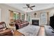 Comfortable living room featuring a fireplace, ceiling fan, and a leather sofa at 1001 Dairy House Ct, Wake Forest, NC 27587