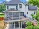 Elevated view of the rear exterior highlighting the deck, screened in porch and outdoor entertaining spaces at 1001 Dairy House Ct, Wake Forest, NC 27587